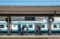 Passengers traveling by rail are waiting for a train on the platform of the resort town of Rimini